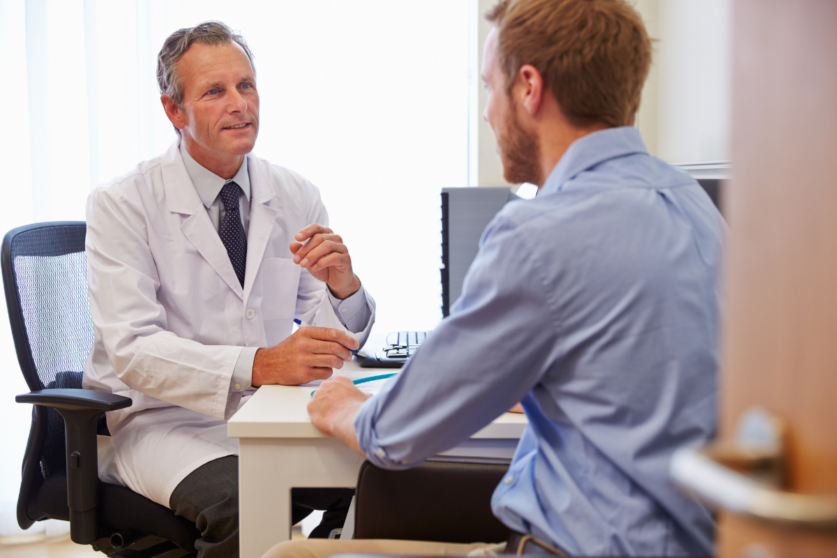A doctor and patient in a consultation room discussing Testosterone deficiency syndrome